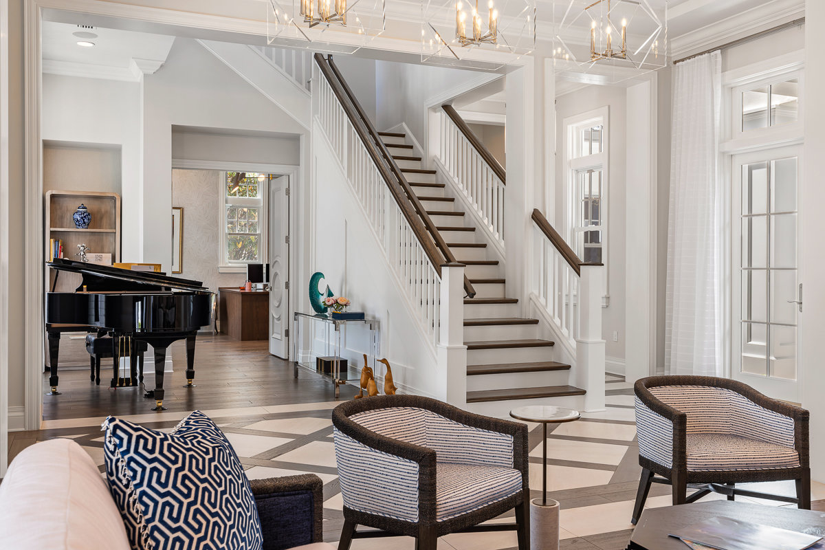 white and brown wood accents with white furniture and stairs